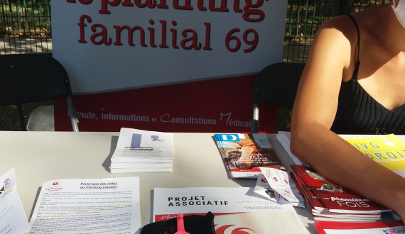 Un stand du Planning Familial 69, avec des brochures, un clito, une affiche du PF69